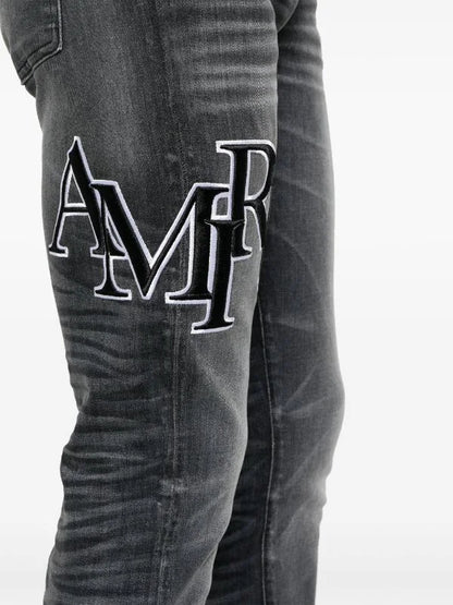 Amiri Men's Faded Skinny Jeans with Staggered Logo